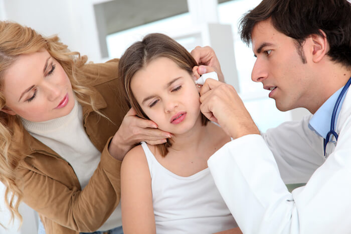 Young girl having her ear checked by a doctor. | The Best Remedy for An Ear Infection