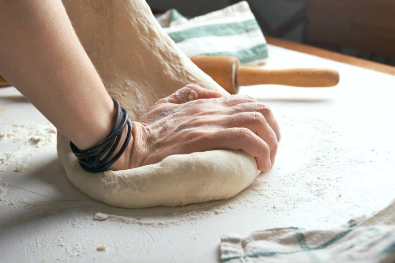 Man kneading dough over table | The Healthiest Bread Recipe In The World